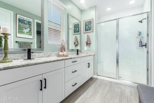 19414 W Highland Ave, Litchfield Park, AZ 85340 - bathroom with recessed lighting, double vanity, a sink, and a stall shower