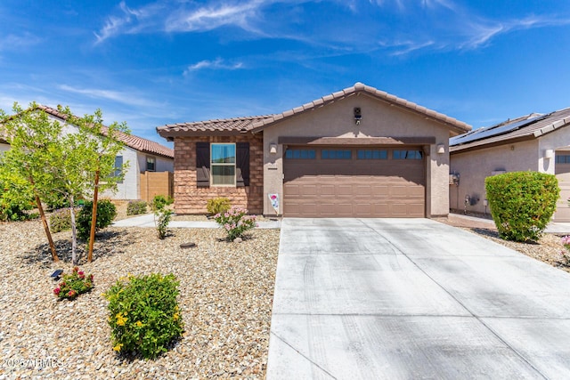 19414 W Highland Ave, Litchfield Park, AZ 85340 - ranch-style home featuring a tiled roof, concrete driveway, an attached garage, stone siding, and stucco siding