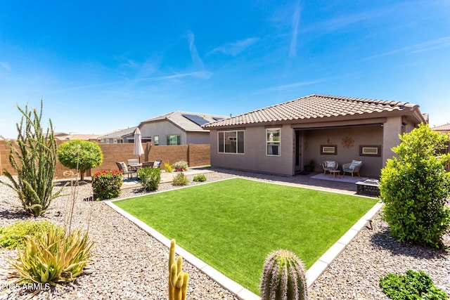 19414 W Highland Ave, Litchfield Park, AZ 85340 - rear view of house with a fenced backyard, a tiled roof, a yard, and a patio area