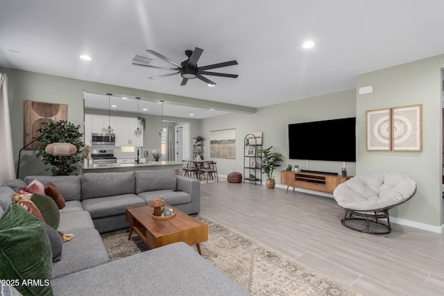 19414 W Highland Ave, Litchfield Park, AZ 85340 - living room featuring ceiling fan, light wood-style flooring, recessed lighting, baseboards, and visible vents