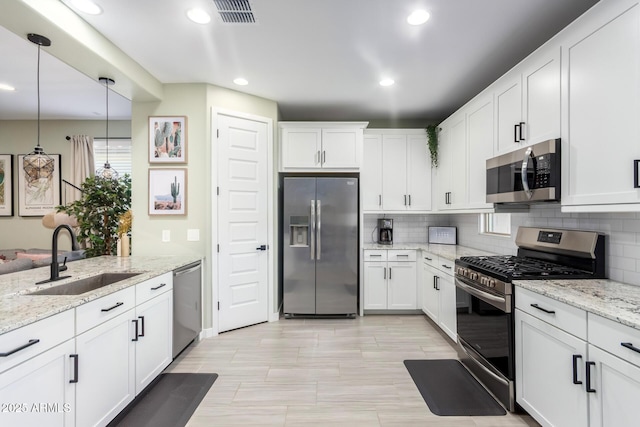 19414 W Highland Ave, Litchfield Park, AZ 85340 - kitchen with visible vents, appliances with stainless steel finishes, tasteful backsplash, a sink, and recessed lighting