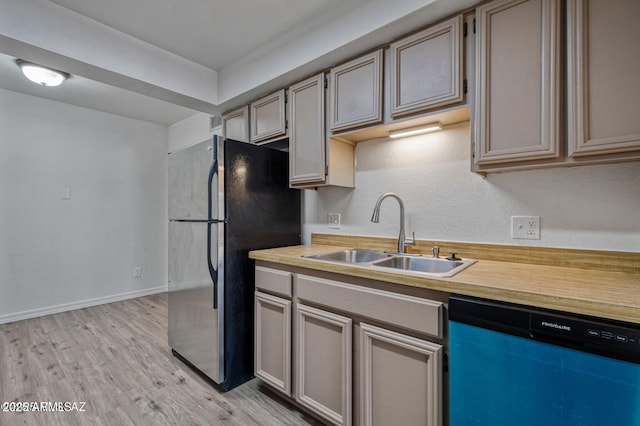 8118 N Gibraltar Dr, Tucson, AZ 85704 - kitchen featuring light countertops, freestanding refrigerator, dishwashing machine, light wood finished floors, and a sink