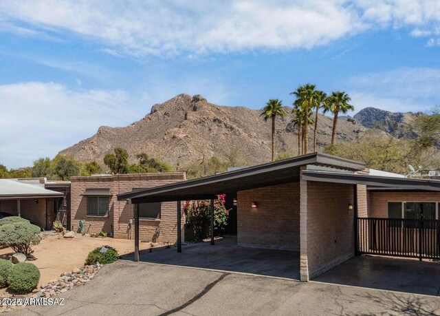 8118 N Gibraltar Dr, Tucson, AZ 85704 - exterior space with a carport, a mountain view, and brick siding