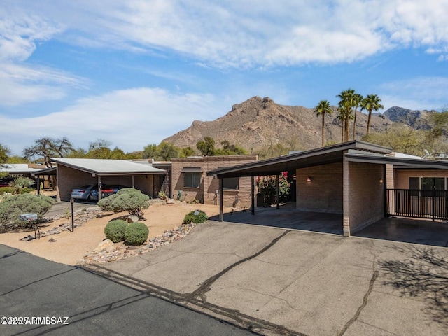 8118 N Gibraltar Dr, Tucson, AZ 85704 - mid-century home featuring an attached carport, brick siding, driveway, and a mountain view
