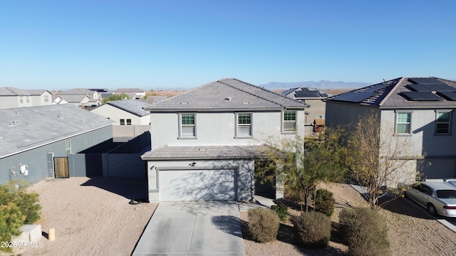 front of property featuring a garage and a mountain view