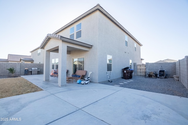 rear view of house featuring a patio