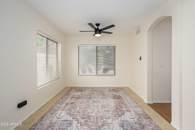 25825 N 65th Ave, Phoenix, AZ 85083 - spare room with baseboards, visible vents, arched walkways, and ceiling fan