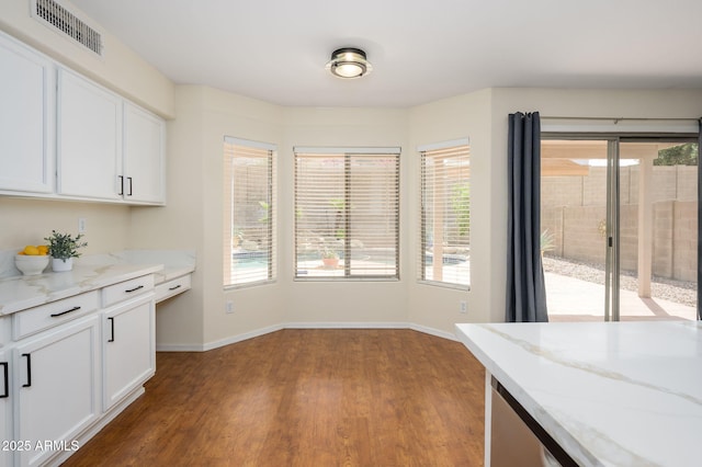 25825 N 65th Ave, Phoenix, AZ 85083 - unfurnished dining area with baseboards, wood finished floors, visible vents, and plenty of natural light