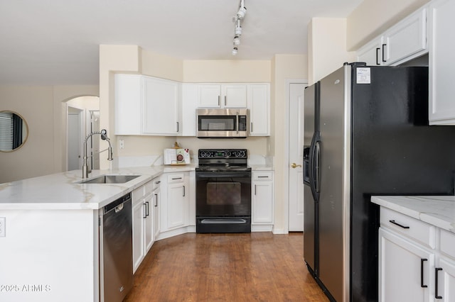 25825 N 65th Ave, Phoenix, AZ 85083 - kitchen with a peninsula, a sink, white cabinetry, and black appliances