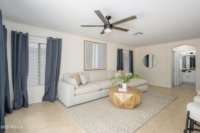 25825 N 65th Ave, Phoenix, AZ 85083 - living room with visible vents, light tile patterned floors, arched walkways, baseboards, and ceiling fan
