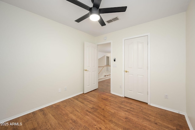 25825 N 65th Ave, Phoenix, AZ 85083 - unfurnished bedroom featuring visible vents, wood finished floors, baseboards, and a ceiling fan
