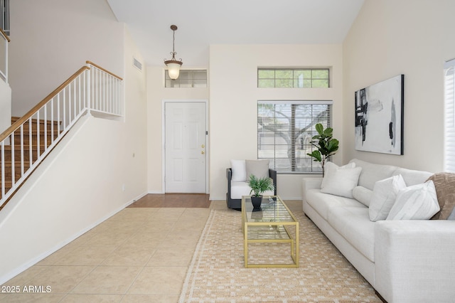 25825 N 65th Ave, Phoenix, AZ 85083 - tiled living room with baseboards, visible vents, a towering ceiling, and stairs