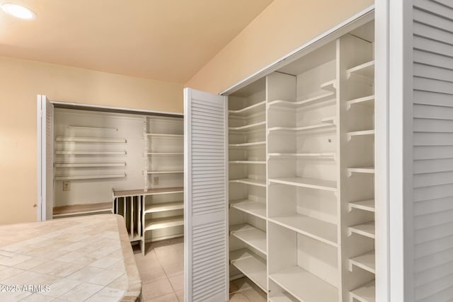 walk in closet with tile patterned flooring