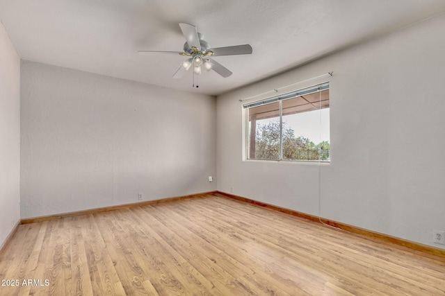 unfurnished room featuring wood finished floors, baseboards, and ceiling fan