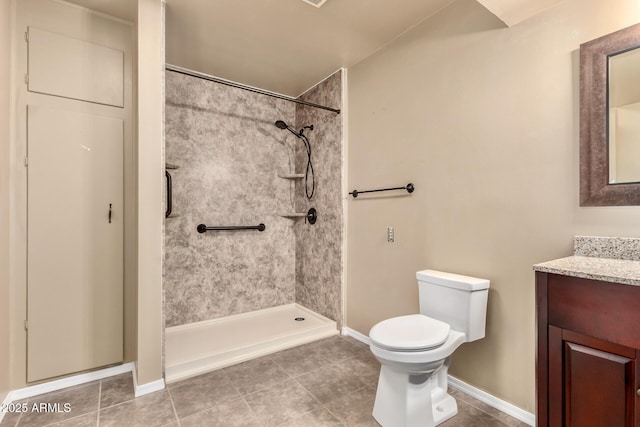 full bath with tile patterned floors, toilet, a shower, baseboards, and vanity