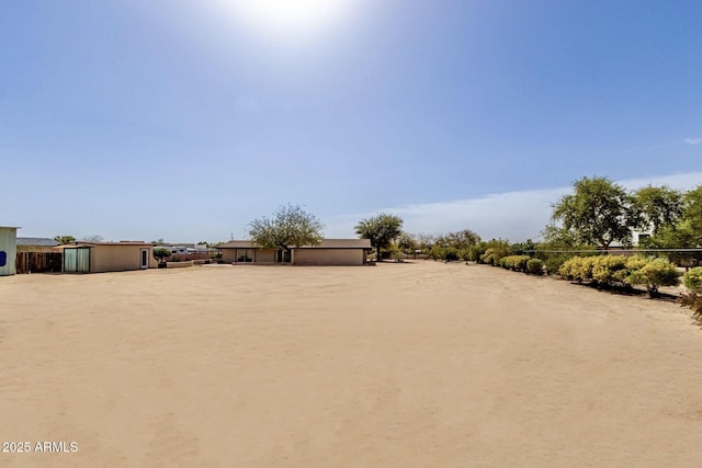 view of yard with an outbuilding and dirt driveway