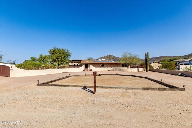 view of front of home featuring fence and a mountain view