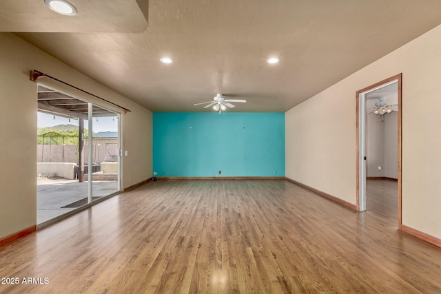 spare room featuring recessed lighting, baseboards, light wood-type flooring, and ceiling fan