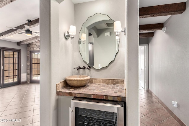 3913 E Derringer Way, Gilbert, AZ 85297 - bathroom with wine cooler, beam ceiling, tile patterned flooring, a ceiling fan, and baseboards