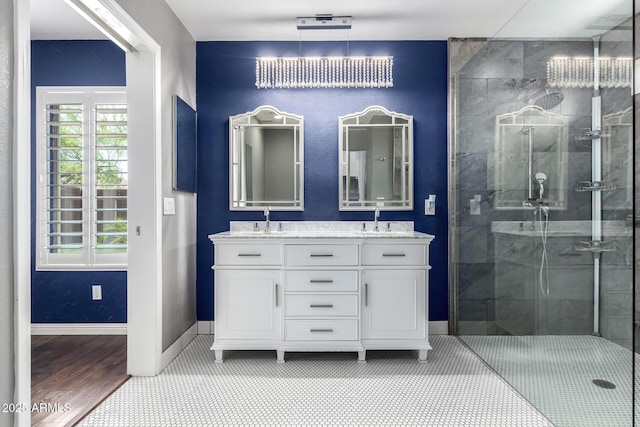 3913 E Derringer Way, Gilbert, AZ 85297 - bathroom with double vanity, a shower stall, and baseboards