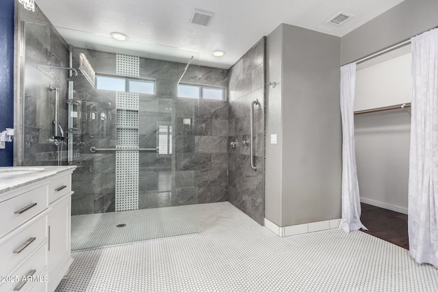 3913 E Derringer Way, Gilbert, AZ 85297 - full bath with tiled shower, vanity, baseboards, and a spacious closet