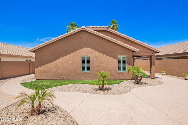 3913 E Derringer Way, Gilbert, AZ 85297 - view of property exterior featuring stucco siding, a fenced backyard, and a patio area
