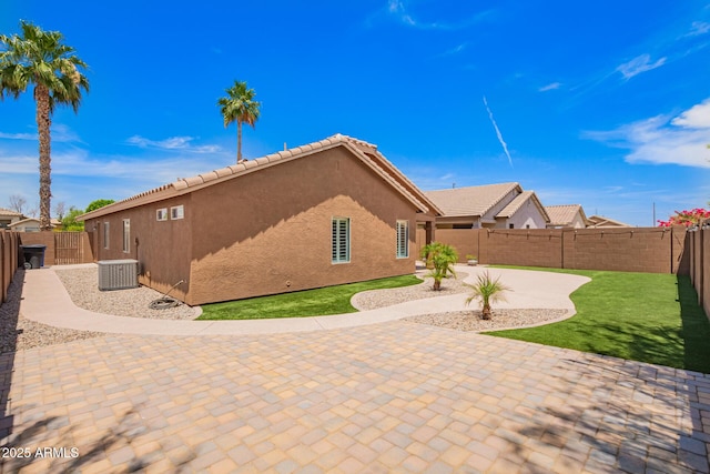 3913 E Derringer Way, Gilbert, AZ 85297 - view of side of property with stucco siding, a patio area, central air condition unit, a fenced backyard, and a tile roof