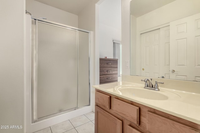 bathroom with tile patterned floors, an enclosed shower, and vanity