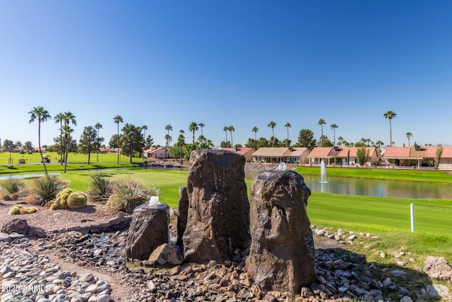 view of property's community featuring a water view and a lawn