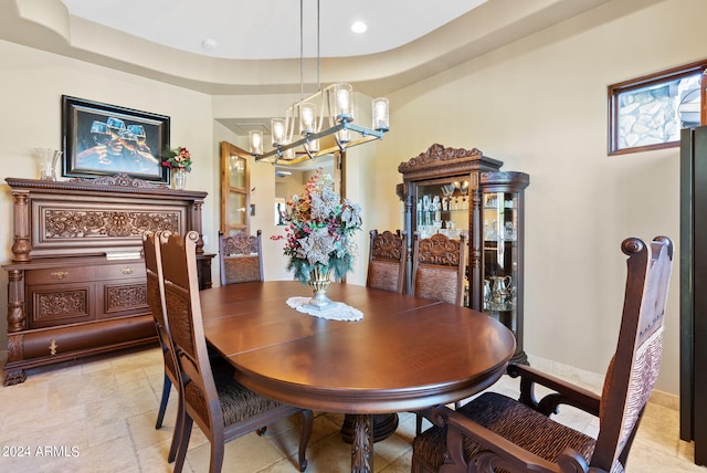 dining room with a chandelier and a tray ceiling