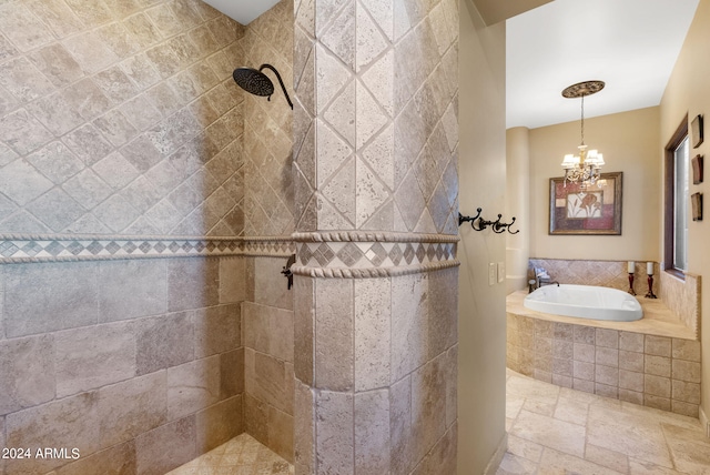 bathroom featuring a notable chandelier and separate shower and tub