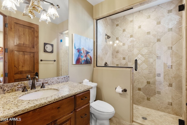 bathroom with vanity, an enclosed shower, a chandelier, and toilet