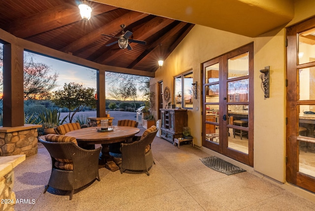 sunroom featuring ceiling fan, french doors, wood ceiling, and a water view