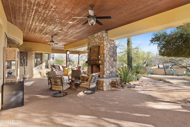 view of patio featuring ceiling fan and an outdoor stone fireplace