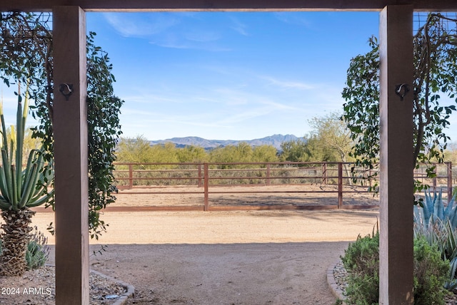 view of yard featuring a rural view and a mountain view