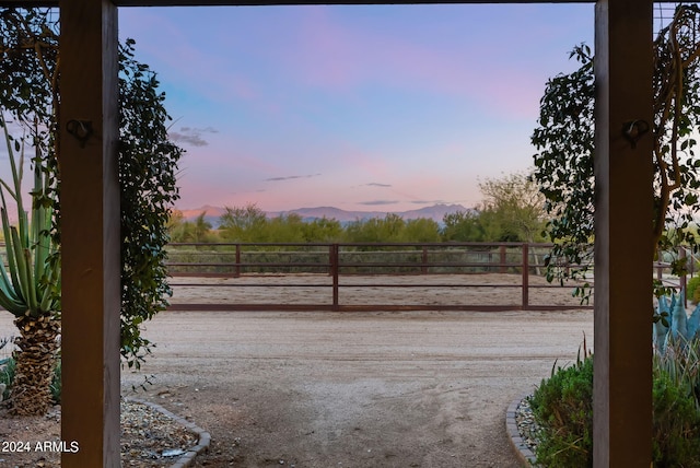 yard at dusk featuring a mountain view