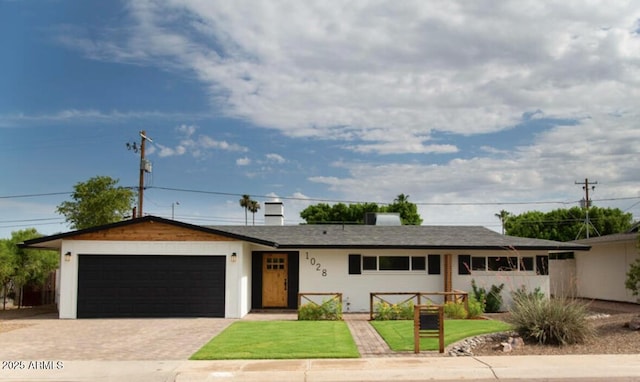 single story home featuring an attached garage and driveway