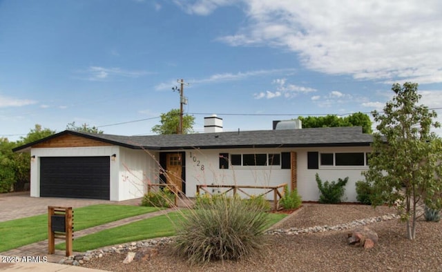 ranch-style house with an attached garage and driveway