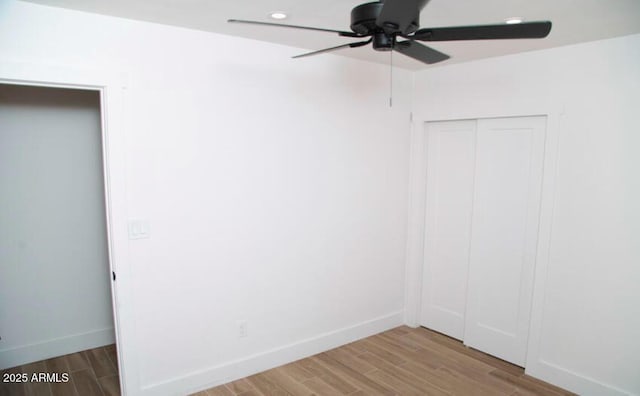 spare room with recessed lighting, a ceiling fan, baseboards, and wood finished floors