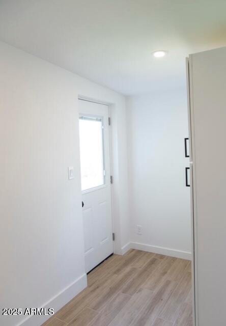 interior space with recessed lighting, baseboards, and light wood finished floors