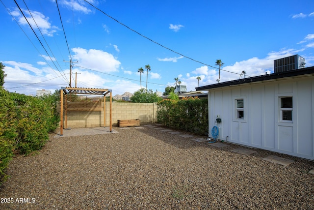 view of yard with central AC and fence private yard