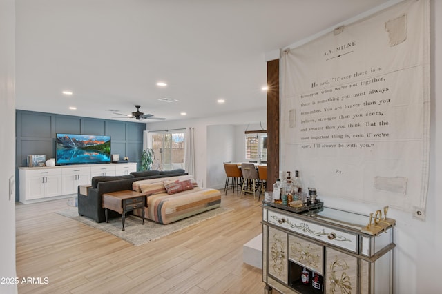 living room with a ceiling fan, recessed lighting, light wood-style floors, and visible vents