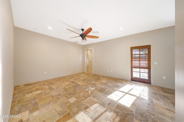 28758 N Ashbrook Ln, San Tan Valley, AZ 85144 - unfurnished room with stone tile flooring, arched walkways, ceiling fan, and recessed lighting