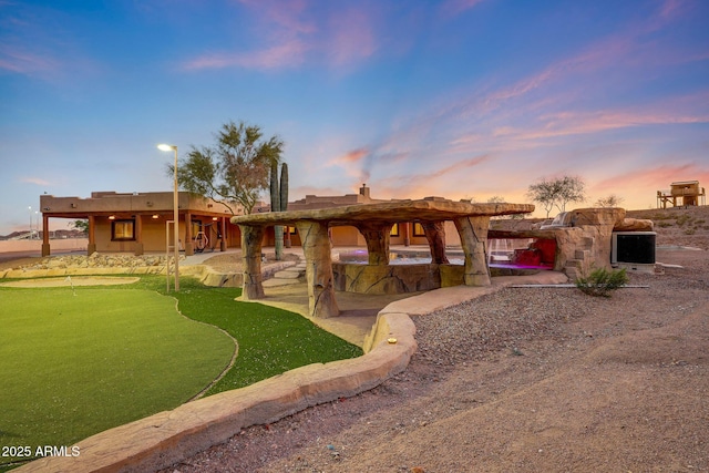 28758 N Ashbrook Ln, San Tan Valley, AZ 85144 - yard at dusk featuring a putting area and a patio area