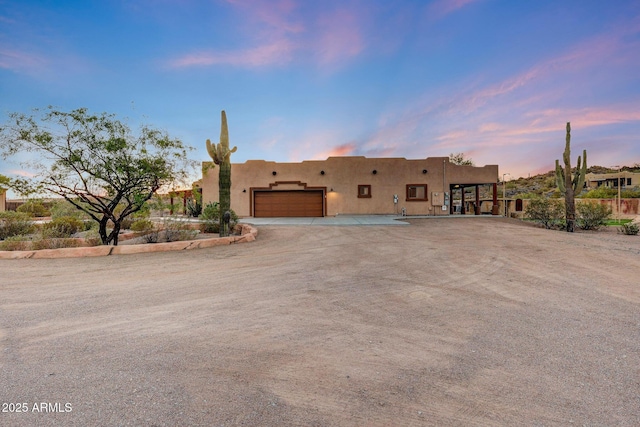 28758 N Ashbrook Ln, San Tan Valley, AZ 85144 - pueblo-style home featuring a garage, stucco siding, and driveway