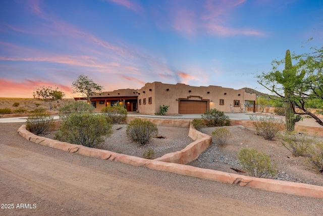 28758 N Ashbrook Ln, San Tan Valley, AZ 85144 - pueblo-style home featuring a garage, stucco siding, and concrete driveway