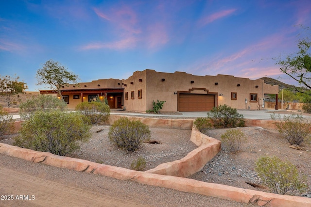 28758 N Ashbrook Ln, San Tan Valley, AZ 85144 - pueblo-style house with a garage, stucco siding, and driveway