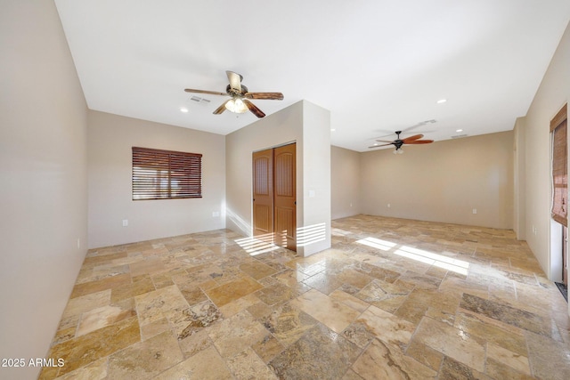 28758 N Ashbrook Ln, San Tan Valley, AZ 85144 - spare room with stone tile floors, ceiling fan, and recessed lighting