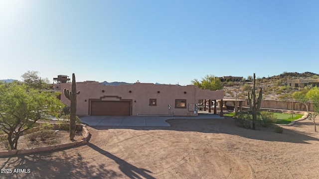 28758 N Ashbrook Ln, San Tan Valley, AZ 85144 - rear view of property featuring a garage, stucco siding, and concrete driveway