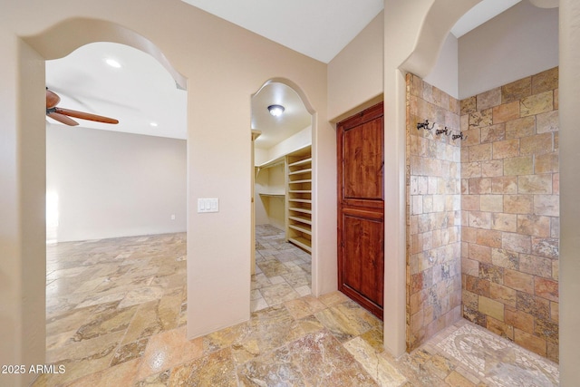 28758 N Ashbrook Ln, San Tan Valley, AZ 85144 - full bath featuring a ceiling fan, a tile shower, stone tile flooring, and a spacious closet